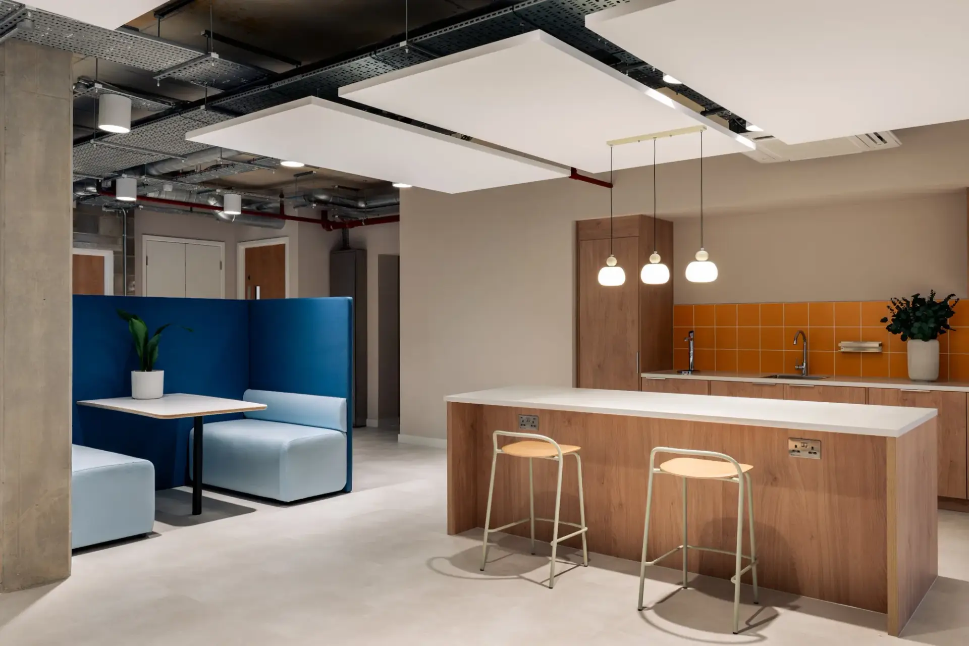 Oak-fronted island and teapoint with orange tiled splashback at The Arc