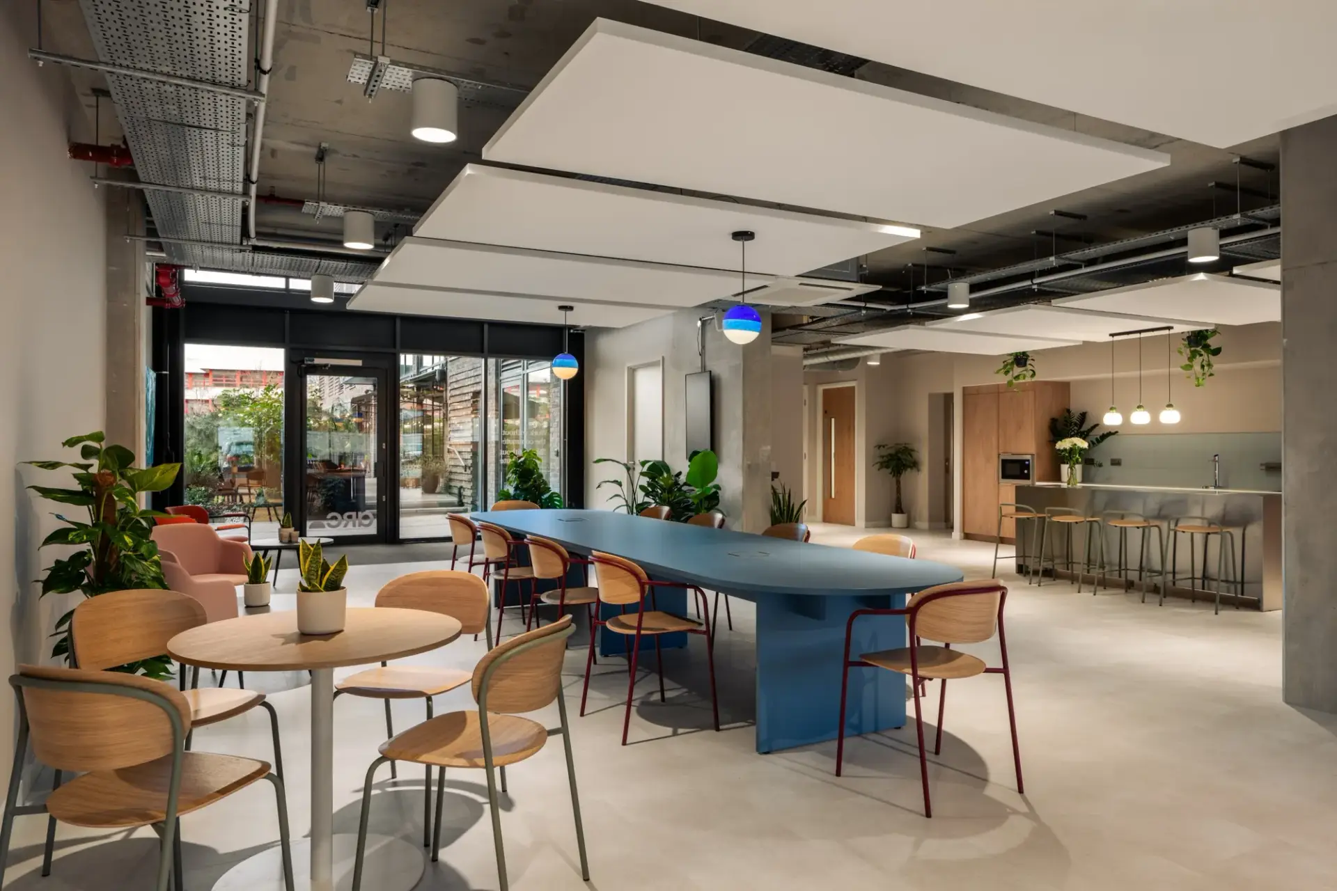 Ground floor workspace at The Arc with shared tables and an oak teapoint